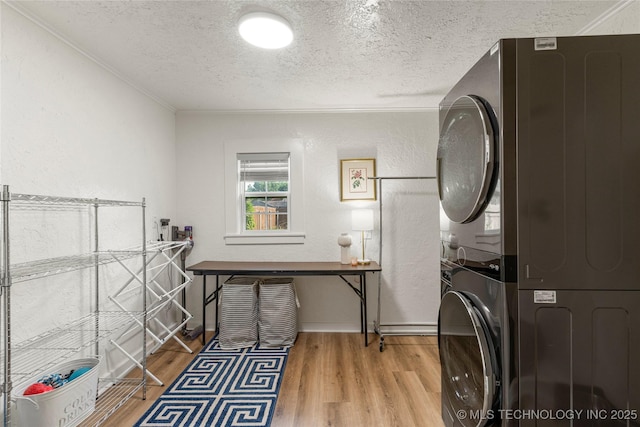 1640 E 41st St, Tulsa, OK 74105 - laundry room featuring stacked washer and clothes dryer, a textured ceiling, wood finished floors, ornamental molding, and a textured wall