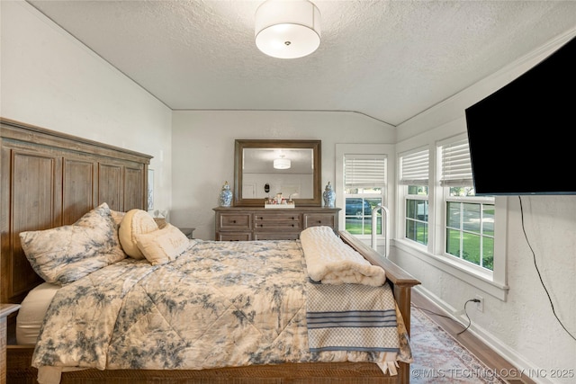 1640 E 41st St, Tulsa, OK 74105 - bedroom featuring a textured ceiling, wood finished floors, and lofted ceiling