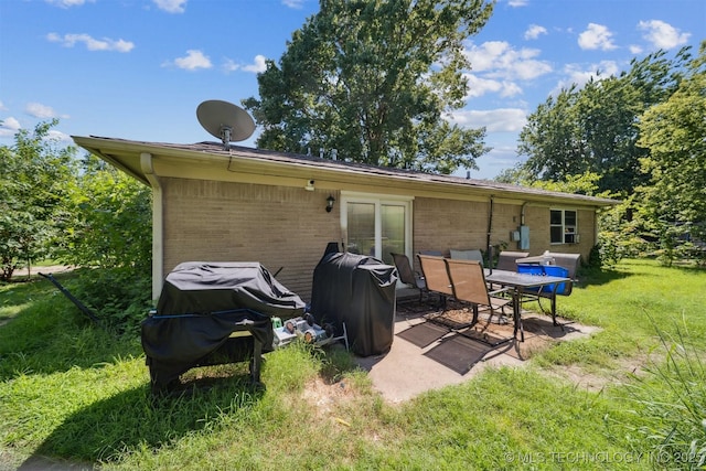 12131 E 32nd Pl, Tulsa, OK 74146 - rear view of property with a yard, brick siding, and a patio