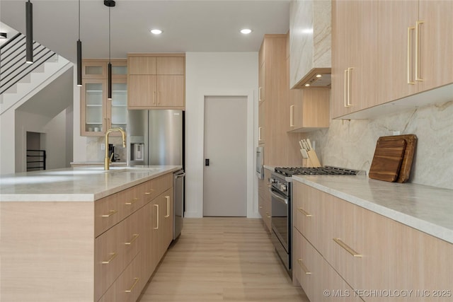 1732 S Jamestown Ave, Tulsa, OK 74112 - kitchen featuring stainless steel appliances, light brown cabinets, modern cabinets, light wood-style flooring, and wall chimney range hood