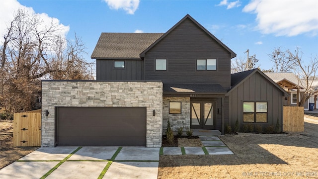 1732 S Jamestown Ave, Tulsa, OK 74112 - view of front of home with driveway, a garage, board and batten siding, stone siding, and a shingled roof
