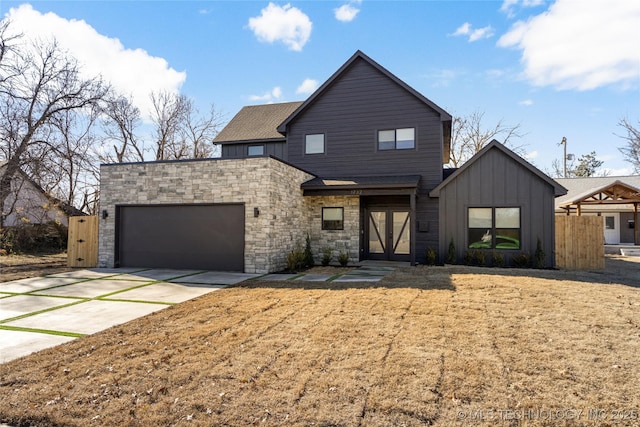 1732 S Jamestown Ave, Tulsa, OK 74112 - contemporary home featuring an attached garage, concrete driveway, board and batten siding, and stone siding