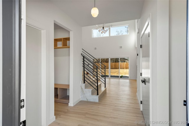 1732 S Jamestown Ave, Tulsa, OK 74112 - foyer entrance with a chandelier, stairway, wood finished floors, and a towering ceiling