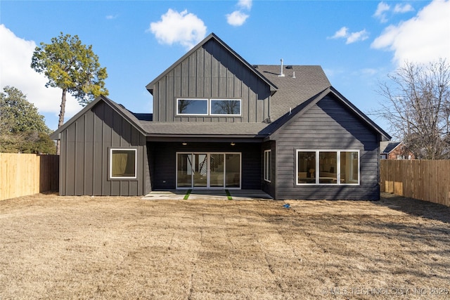 1732 S Jamestown Ave, Tulsa, OK 74112 - back of property with board and batten siding, a fenced backyard, and a patio
