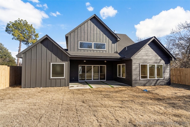 1732 S Jamestown Ave, Tulsa, OK 74112 - rear view of property featuring board and batten siding, a fenced backyard, and a patio area