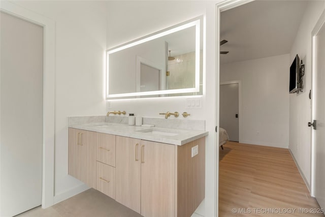 1732 S Jamestown Ave, Tulsa, OK 74112 - full bath featuring double vanity, wood finished floors, connected bathroom, and a ceiling fan