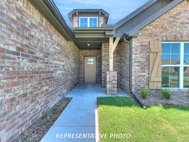 9533 E 131st Pl S, Bixby, OK 74008 - view of exterior entry with brick siding and a yard