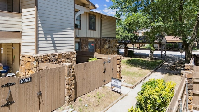 6376 S 80th E Ave Unit G, Tulsa, OK 74133 - view of home's exterior with stone siding