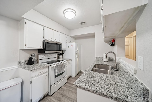 6376 S 80th E Ave Unit G, Tulsa, OK 74133 - kitchen featuring white appliances, white cabinets, light wood finished floors, and light stone countertops