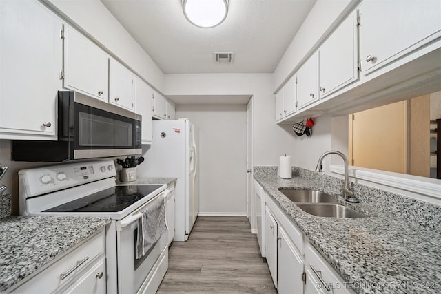 6376 S 80th E Ave Unit G, Tulsa, OK 74133 - kitchen featuring white appliances, white cabinetry, light wood-style flooring, and light stone countertops