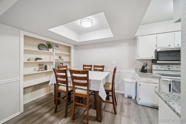 6376 S 80th E Ave Unit G, Tulsa, OK 74133 - dining space featuring light wood-type flooring and a raised ceiling