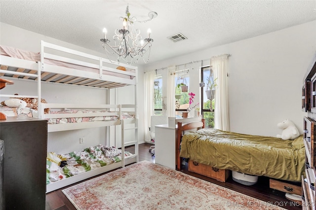 1508 Melissa Cir, Sapulpa, OK 74066 - bedroom featuring wood finished floors, a chandelier, and a textured ceiling
