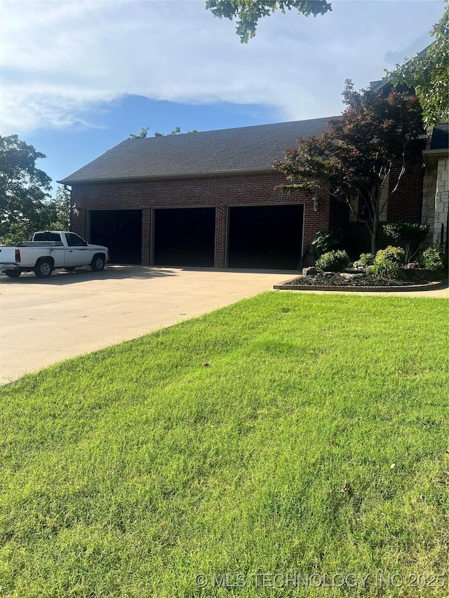910 Summit Rdg, Mcalester, OK 74501 - view of property exterior with concrete driveway, an attached garage, a yard, and brick siding