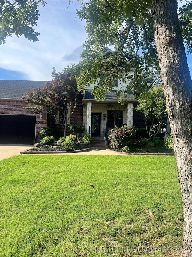 910 Summit Rdg, Mcalester, OK 74501 - view of property hidden behind natural elements with a garage, a front yard, concrete driveway, and stone siding