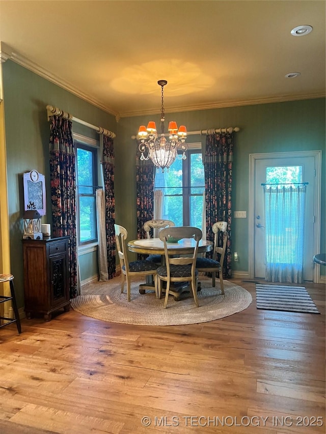 910 Summit Rdg, Mcalester, OK 74501 - dining space featuring a chandelier, ornamental molding, healthy amount of natural light, and wood finished floors