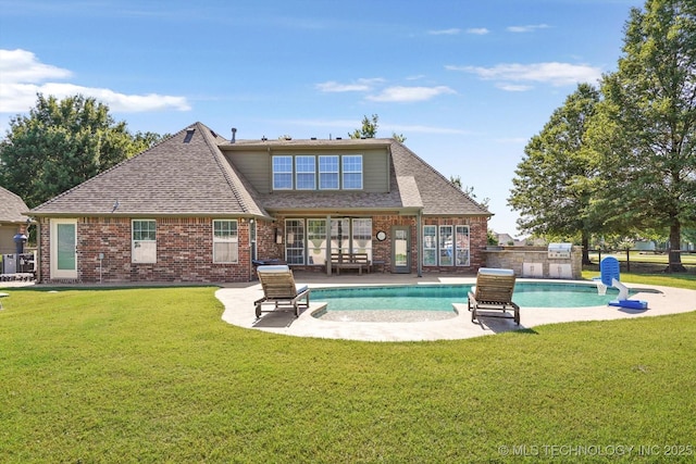 7185 N 194th E Ave, Owasso, OK 74055 - back of property with a patio, brick siding, and a lawn