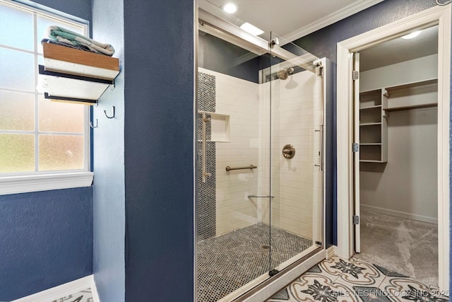 7185 N 194th E Ave, Owasso, OK 74055 - bathroom featuring a stall shower, ornamental molding, a textured wall, and a walk in closet