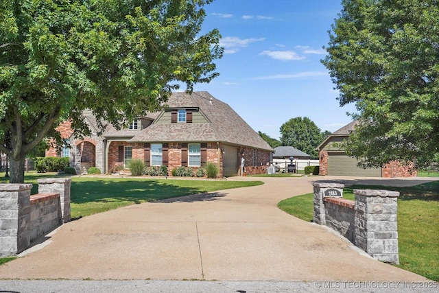 7185 N 194th E Ave, Owasso, OK 74055 - view of front of property with a garage, brick siding, a front yard, and concrete driveway