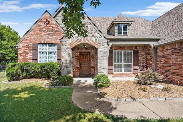 7185 N 194th E Ave, Owasso, OK 74055 - view of front facade featuring brick siding, stone siding, and a shingled roof