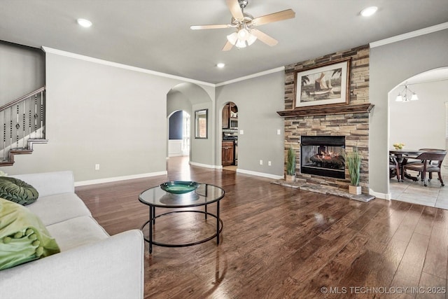 7185 N 194th E Ave, Owasso, OK 74055 - living room featuring arched walkways, wood finished floors, ornamental molding, a ceiling fan, and recessed lighting