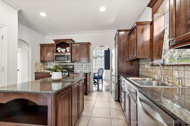 7185 N 194th E Ave, Owasso, OK 74055 - kitchen with open shelves, appliances with stainless steel finishes, arched walkways, crown molding, and backsplash