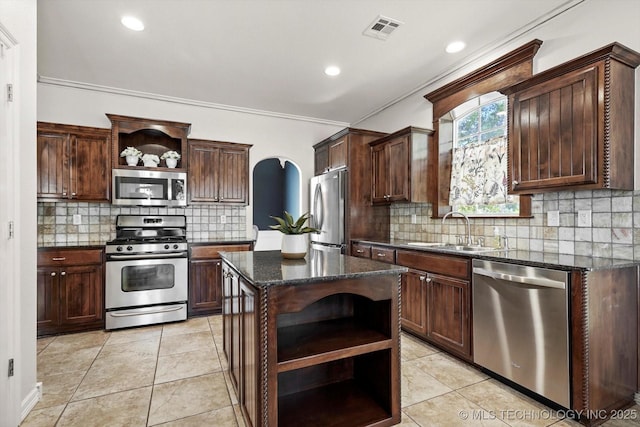 7185 N 194th E Ave, Owasso, OK 74055 - kitchen featuring open shelves, stainless steel appliances, arched walkways, tasteful backsplash, and dark stone countertops