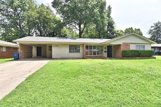 5701 S Rockford Pl, Tulsa, OK 74105 - ranch-style home featuring concrete driveway, a front lawn, a carport, and brick siding