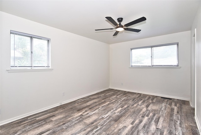 5701 S Rockford Pl, Tulsa, OK 74105 - spare room with healthy amount of natural light, dark wood-style flooring, and a ceiling fan