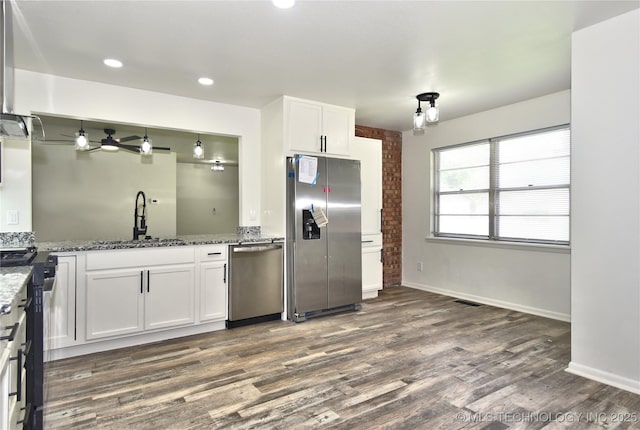 5701 S Rockford Pl, Tulsa, OK 74105 - kitchen with stainless steel appliances, dark wood-style flooring, white cabinetry, stone countertops, and recessed lighting