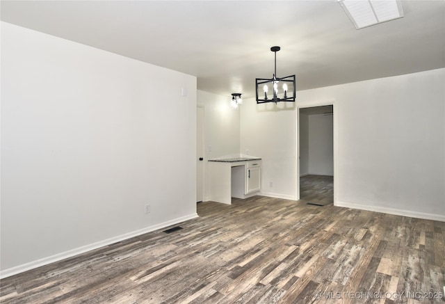 5701 S Rockford Pl, Tulsa, OK 74105 - unfurnished dining area with dark wood-style flooring and a chandelier