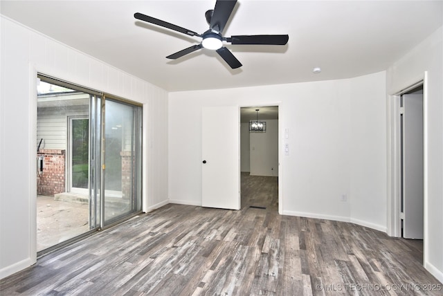 5701 S Rockford Pl, Tulsa, OK 74105 - spare room featuring wood finished floors, ceiling fan, and a chandelier