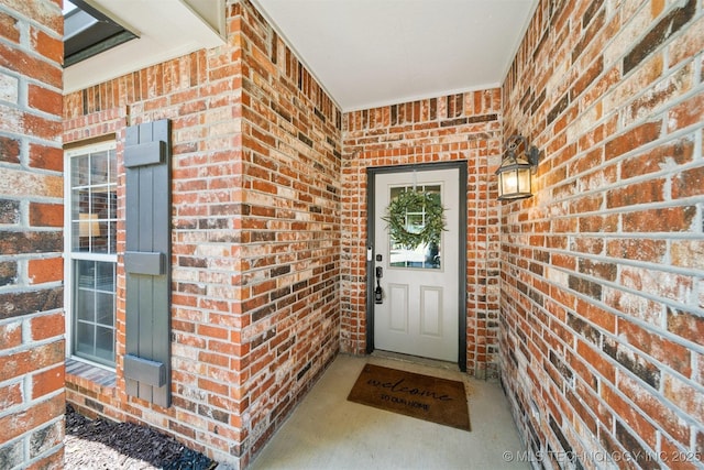 14003 E 87th Pl N, Owasso, OK 74055 - doorway to property featuring brick siding and covered porch