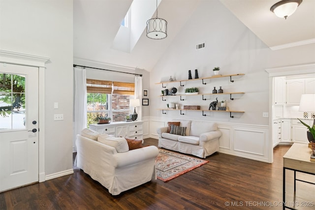14003 E 87th Pl N, Owasso, OK 74055 - living room featuring dark wood finished floors, high vaulted ceiling, and a wainscoted wall