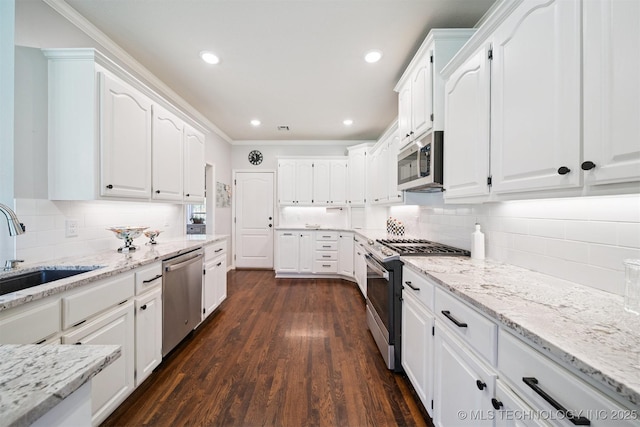 14003 E 87th Pl N, Owasso, OK 74055 - kitchen featuring stainless steel appliances, white cabinetry, light stone countertops, dark wood finished floors, and recessed lighting