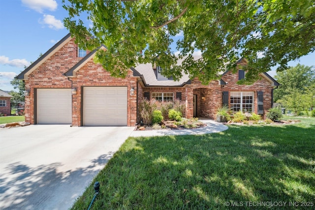 14003 E 87th Pl N, Owasso, OK 74055 - view of front of property with a garage, a front yard, concrete driveway, and brick siding