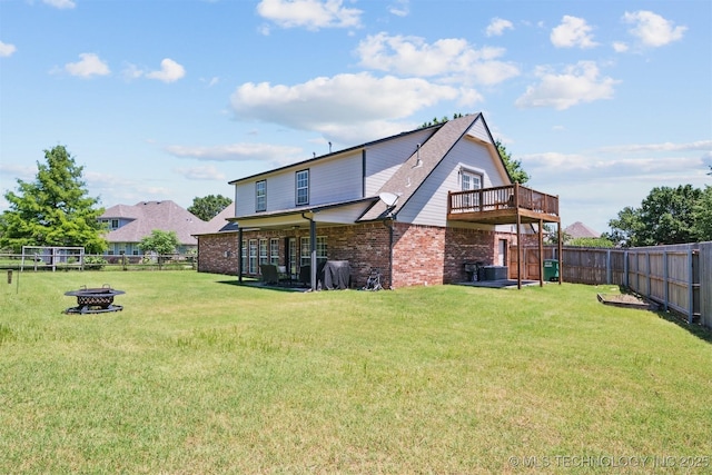 14003 E 87th Pl N, Owasso, OK 74055 - back of property with brick siding, a fenced backyard, a fire pit, and a wooden deck
