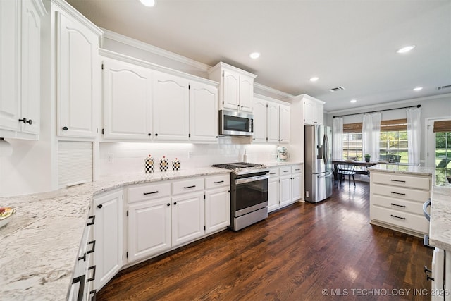 14003 E 87th Pl N, Owasso, OK 74055 - kitchen with appliances with stainless steel finishes, crown molding, white cabinets, tasteful backsplash, and recessed lighting