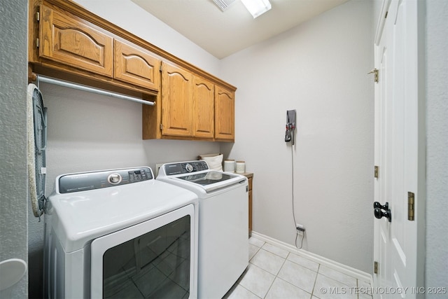 14003 E 87th Pl N, Owasso, OK 74055 - laundry room with washing machine and clothes dryer, cabinet space, and light tile patterned floors