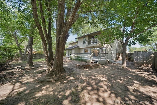 8912 S 70th E Ave, Tulsa, OK 74133 - fenced backyard with a balcony and a wooden deck