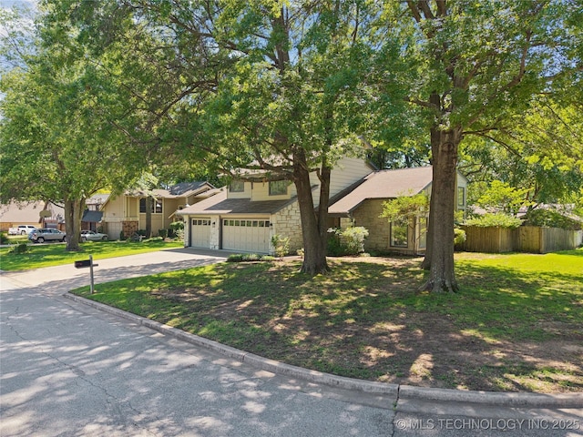 8912 S 70th E Ave, Tulsa, OK 74133 - obstructed view of property featuring driveway, stone siding, and a residential view