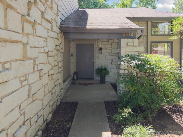 8912 S 70th E Ave, Tulsa, OK 74133 - entrance to property featuring stone siding and roof with shingles