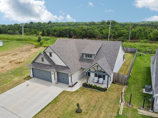 7413 N 160th E Ave, Owasso, OK 74055 - view of front of home with an attached garage, a shingled roof, concrete driveway, and a view of trees