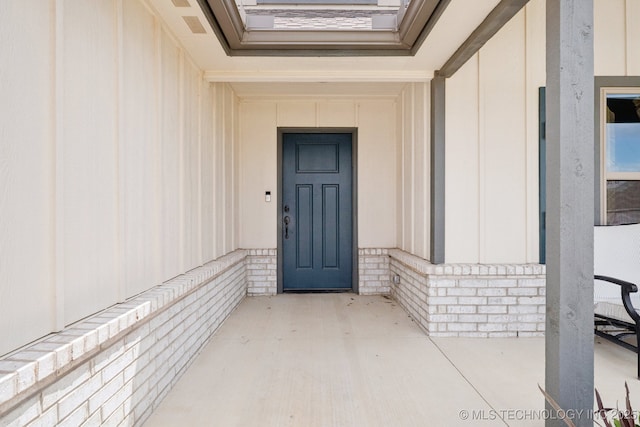 7413 N 160th E Ave, Owasso, OK 74055 - doorway to property featuring board and batten siding