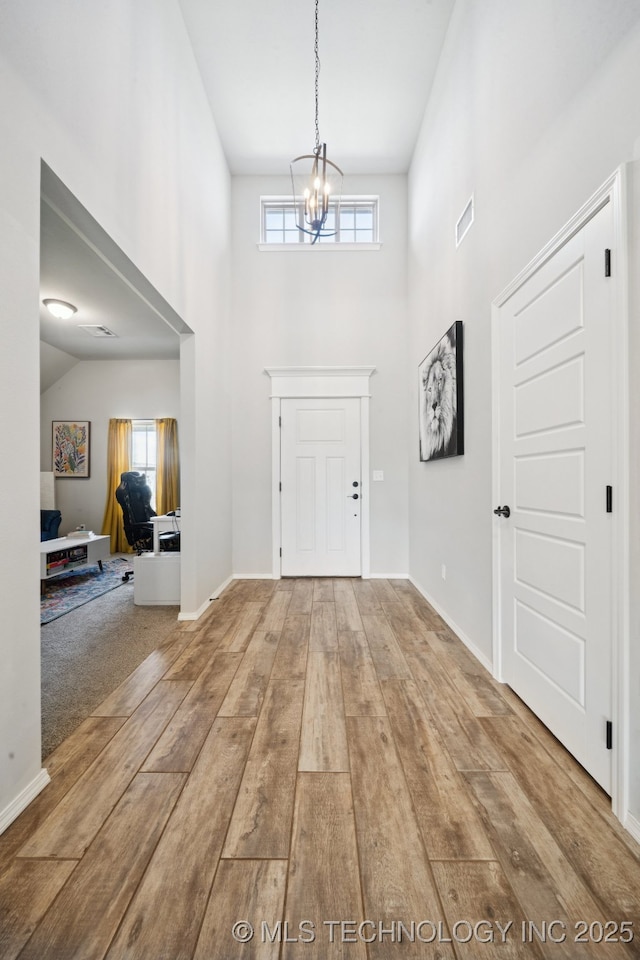 7413 N 160th E Ave, Owasso, OK 74055 - foyer entrance featuring a chandelier, plenty of natural light, hardwood / wood-style floors, and a high ceiling