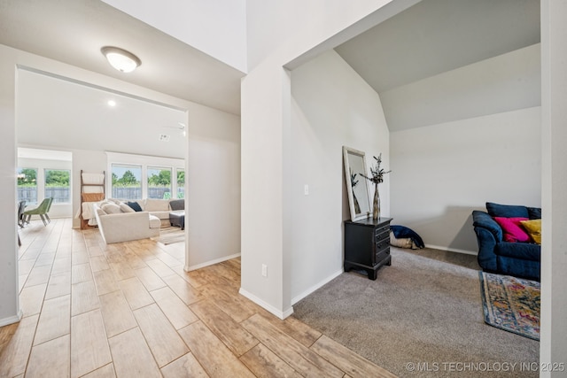 7413 N 160th E Ave, Owasso, OK 74055 - corridor with light wood-style floors and vaulted ceiling