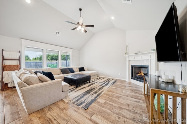 7413 N 160th E Ave, Owasso, OK 74055 - living room with a ceiling fan, light wood-style flooring, a tile fireplace, recessed lighting, and high vaulted ceiling