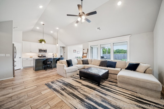 7413 N 160th E Ave, Owasso, OK 74055 - living area with high vaulted ceiling, light wood-type flooring, ceiling fan, and recessed lighting