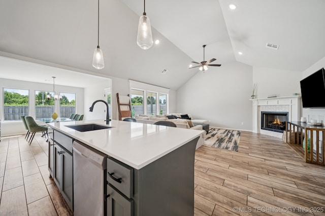 7413 N 160th E Ave, Owasso, OK 74055 - kitchen featuring dishwasher, vaulted ceiling, open floor plan, ceiling fan, and light countertops