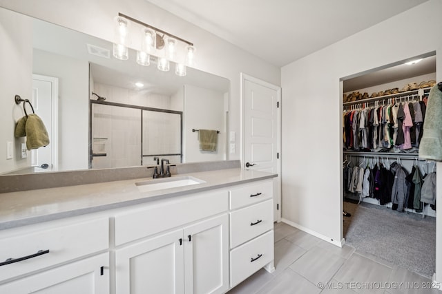 7413 N 160th E Ave, Owasso, OK 74055 - full bathroom with vanity, a shower stall, and a spacious closet