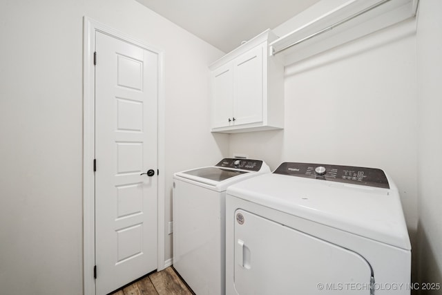 7413 N 160th E Ave, Owasso, OK 74055 - laundry area with washing machine and clothes dryer, cabinet space, and wood finished floors